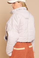 Designed in quilted jacket with zipper closure